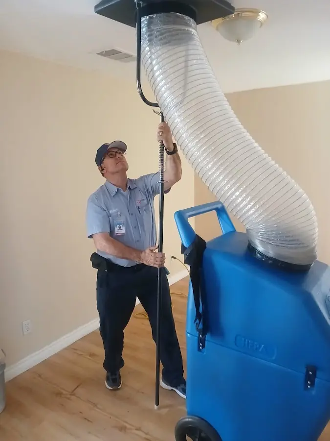 Furnace Tune-Up technician using HEPA equipment in San Mateo