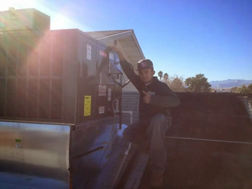 HVAC technician performing HVAC Inspection on a rooftop unit in San Mateo